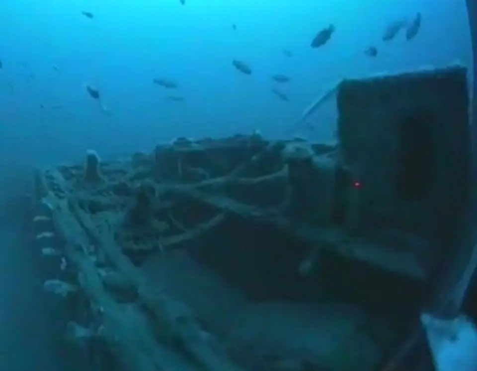 Wreck of the SS Nemesis on the seabed, sitting upright on a sand plain